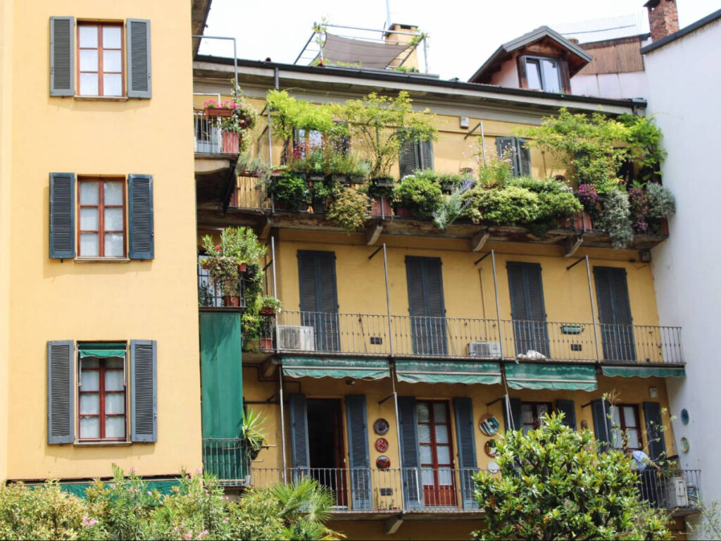 A colorful building with plants in Central neighborhood of Milan