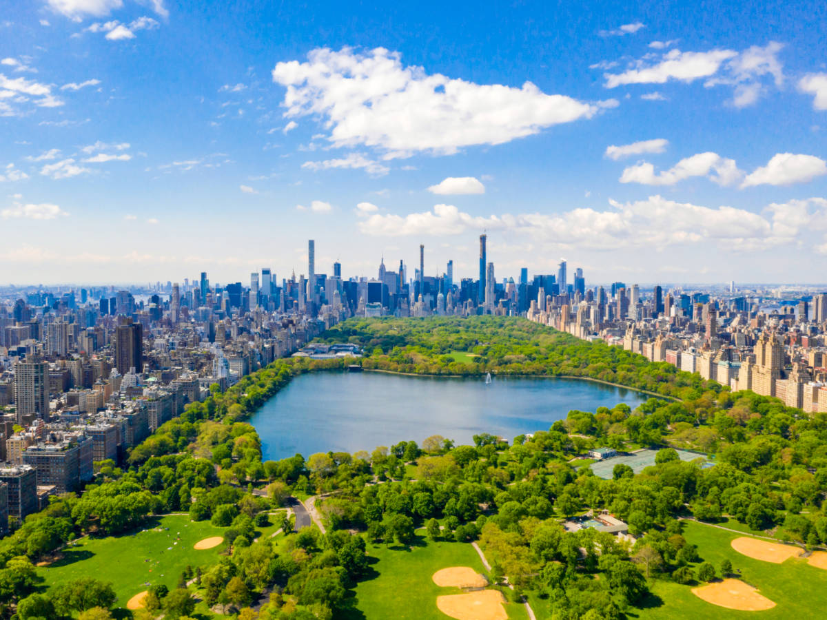 Aerial view of the Central park in New York with golf fields and tall skyscrapers surrounding the park