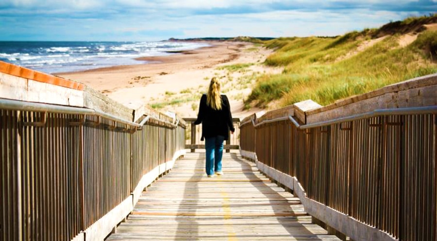 The author descending a staircase going to the beach in Prince Edward Island