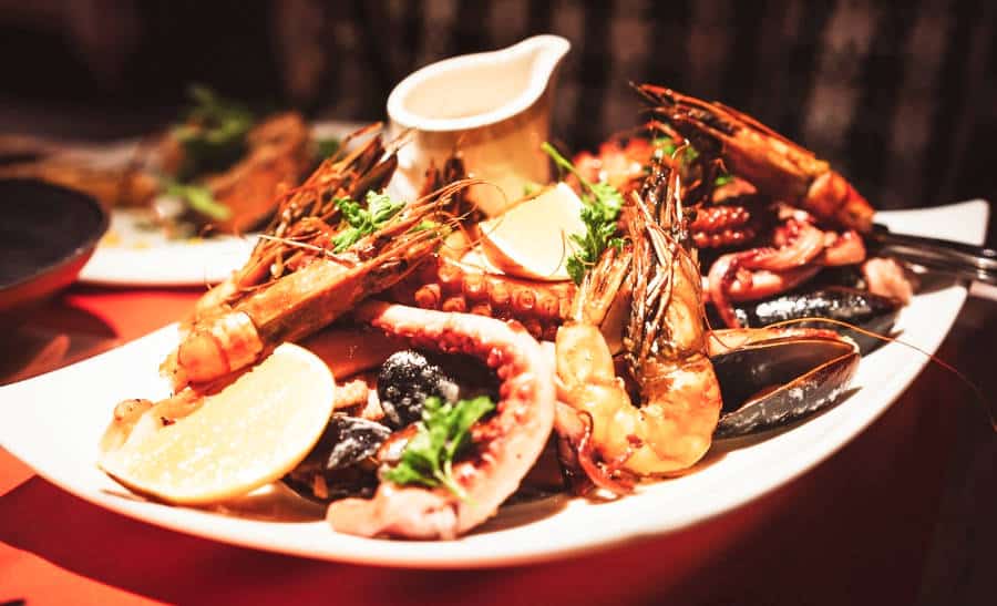 A seafood gourmet on a table with a red tablecloth in a Portuguese restaurant