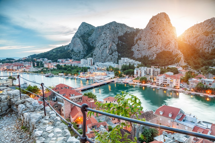The Cetina River flows through the town of Omis as the sun sets