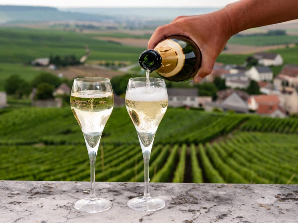 Glasses of champagne with a vineyard on the background at the Champagne Region