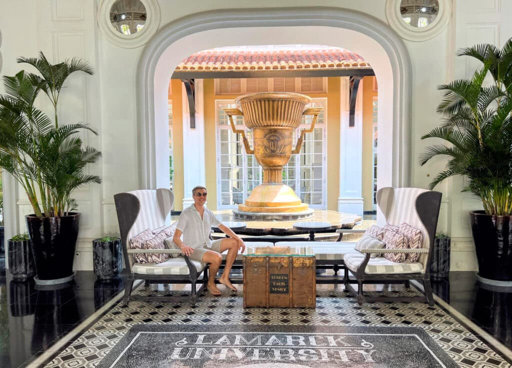 Nate sitting at the lobby with the championship cup on his background