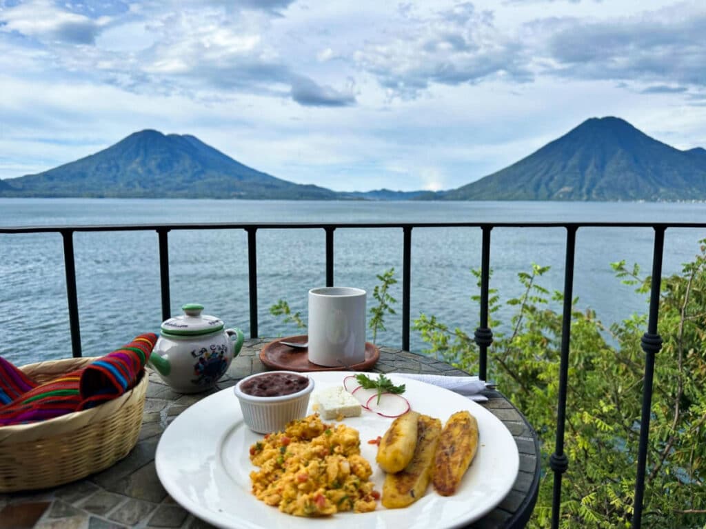 A plate of Chapin breakfast and a cup of coffee in the balcony of La Casa del Mundo