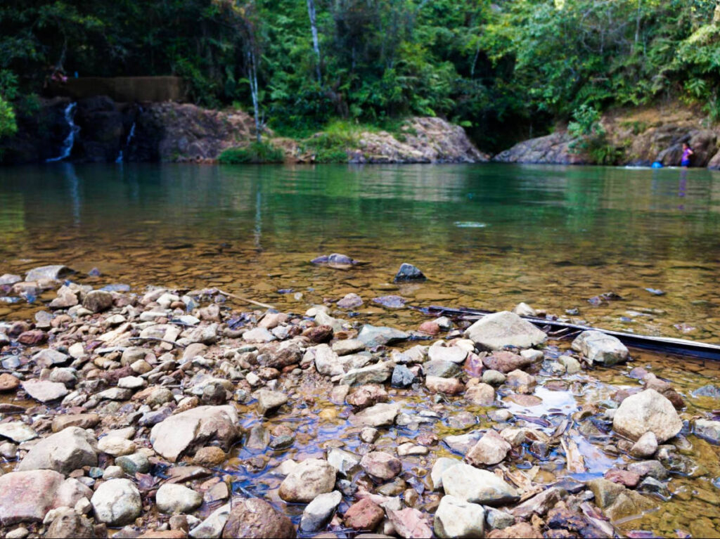 Scenic view of the calm Charco Azul waterhole surrounded by greenery