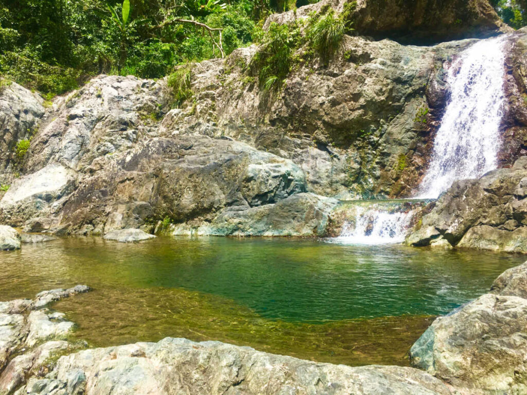 Serene Charco El Ataud waterfall cascading through the lush jungle and rocks