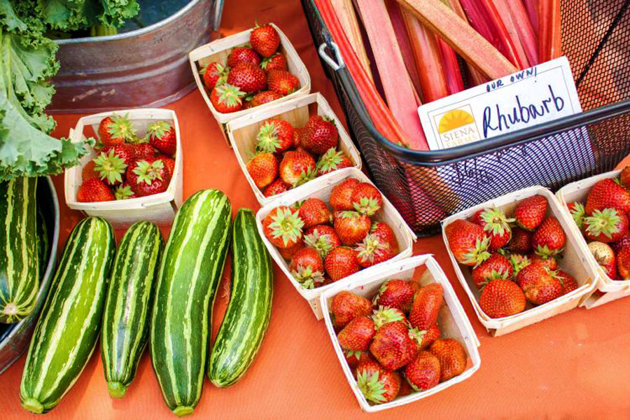 View of fresh cucumbers and strawberries on a table