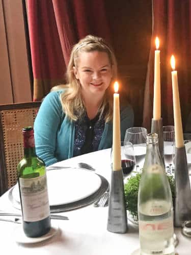 The author, Rachel Kapelke-Dale smiling for a photo at the Château de Saint-Paterne
