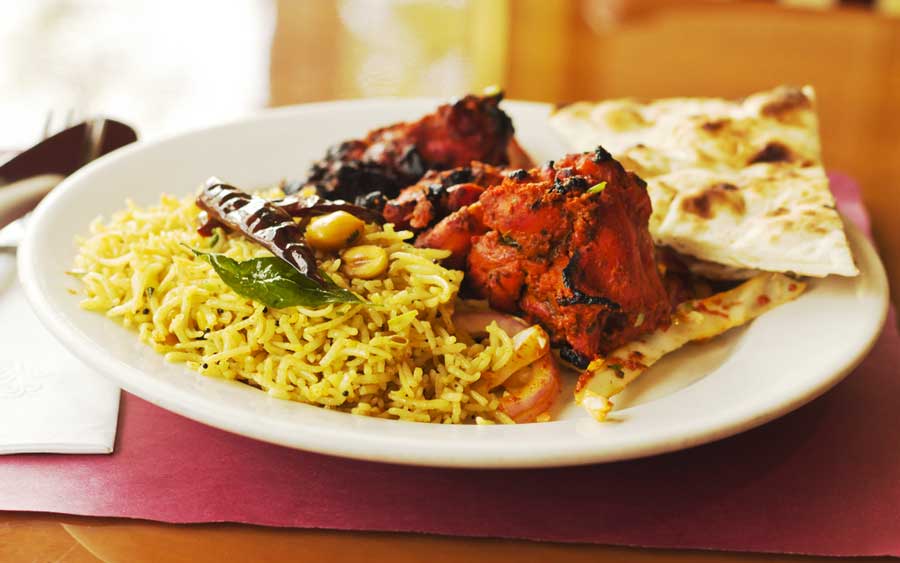 View of a Tandoori chicken with naan in Chauhan Ale & Masala House