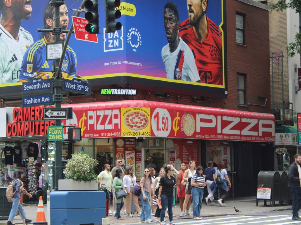 View of a cheap pizza signage from across the street