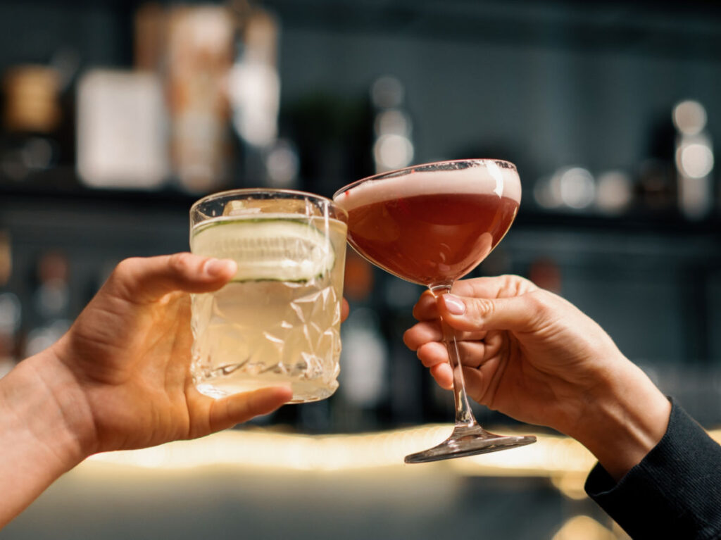 A couple cheering cocktails in Park & Rec