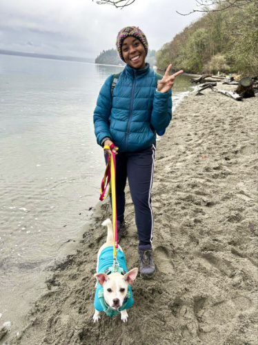 The author Chelsea Booker and her dog, posing at the Dash Point State Park waterfront