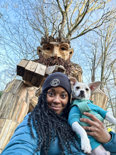 The author Chelsea Booker and her dog, posing for a photo with Oscar The Bird King