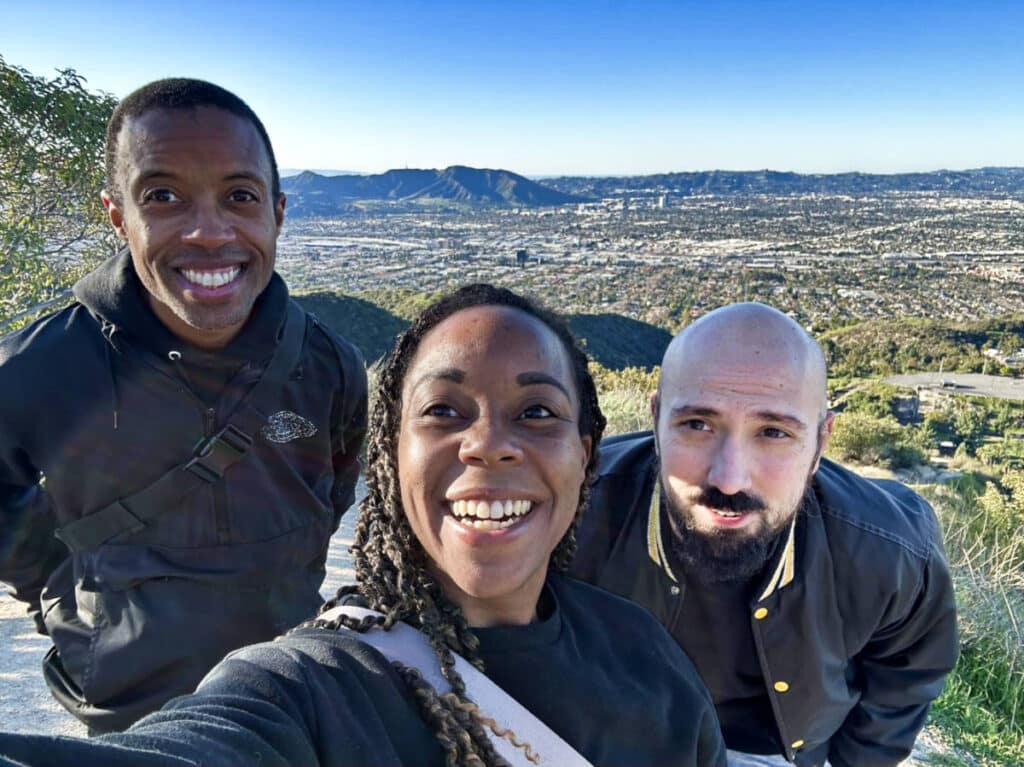 The author Chelsea Booker with her husband and brother, posing for a photo in the trail