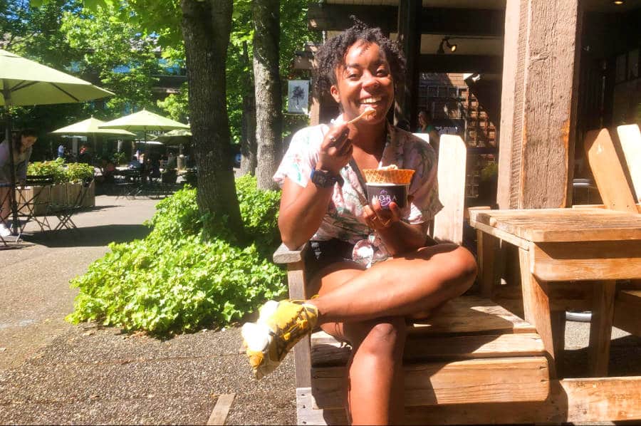 The author Chelsea Booker eating ice cream in Winslow on a sunny day