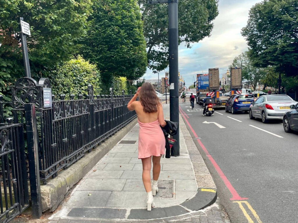 The author, Brooke Horrobin walking on a sidewalk to Chelsea embankment in London
