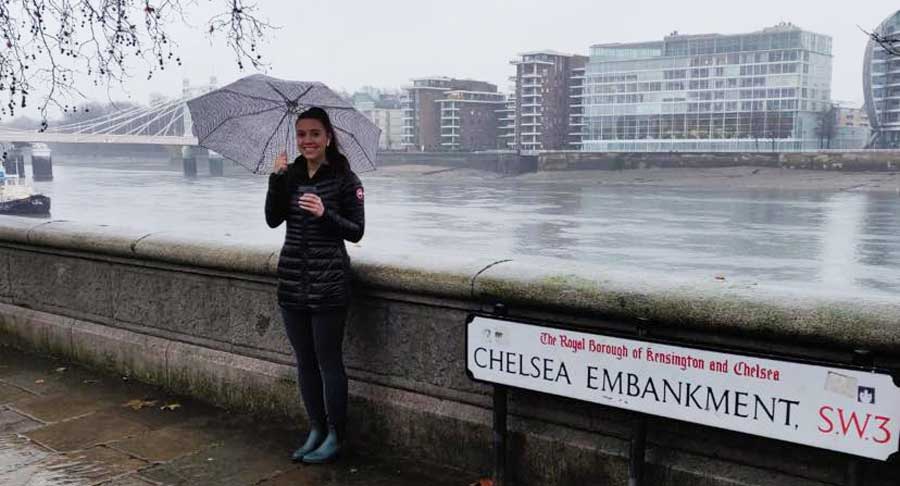 The author standing in Chelsea Embankment while holding an umbrella during a rainy morning