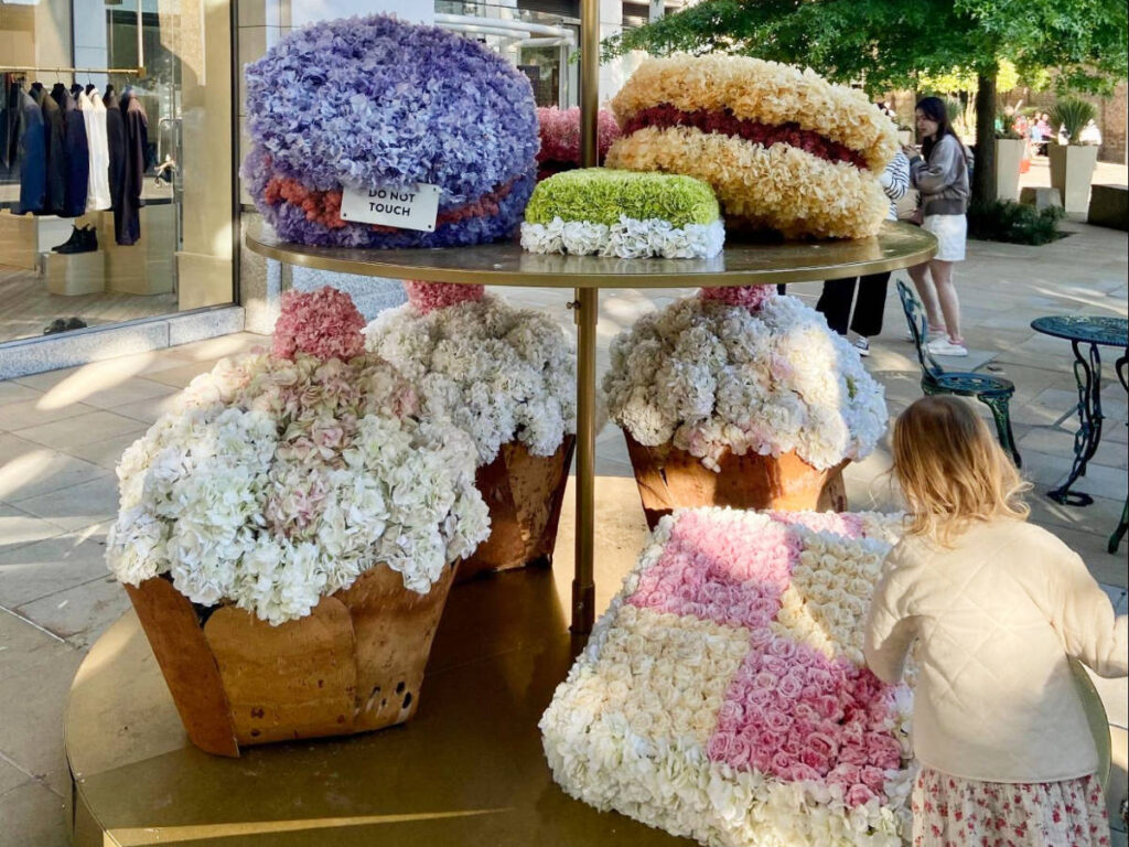 A girl admiring the dessert replica flowers at the Chelsea Flower Show in London