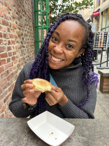 The author Chelsea Booker holding a piece of tart