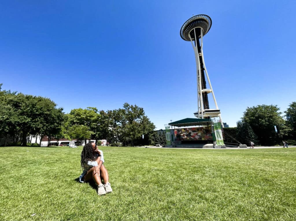 The author Chelsea Booker, looking up at the Space Needle on a sunny day