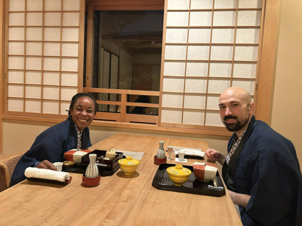 The author Chelsea Booker and her husband in front of the table with kaiseki dinner