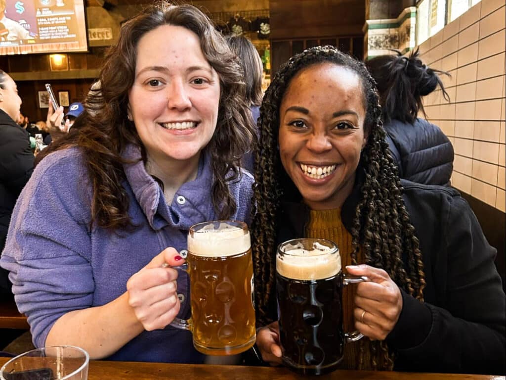 The author Chelsea Booker and her sister-in-law, posing for a photo with their glass of beers