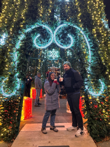 The author Chelsea Booker with her husband holding their glasses of mulled wine