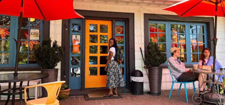 The author standing at the entrance of C & P Coffee Company in Seattle, Washington