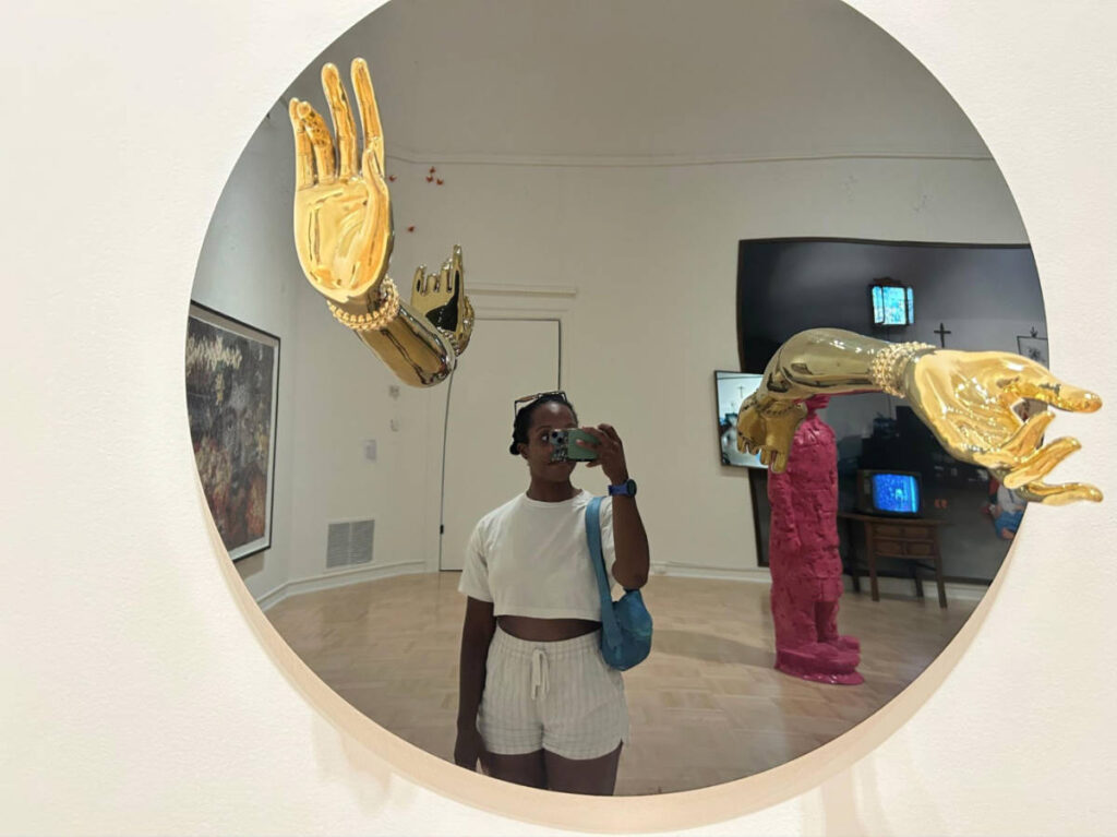 The author Chelsea Booker, taking a photo through the mirror with art installation at Henry Art Gallery