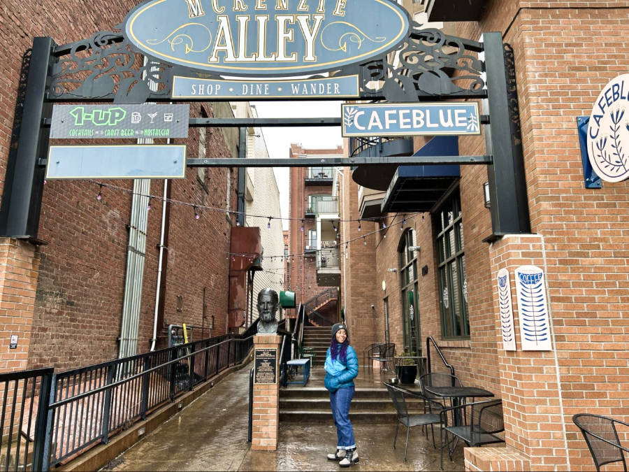 The author, Chelsea, posing at the entrance of Mckenzie Alley in Fairhaven