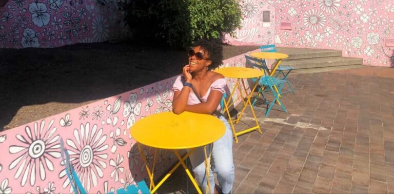 The author Chelsea Booker posing for a photo on a sunny day