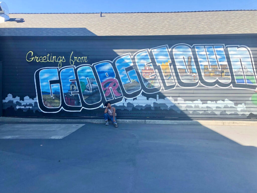 The author Chelsea Booker, in front of a mural in Georgetown