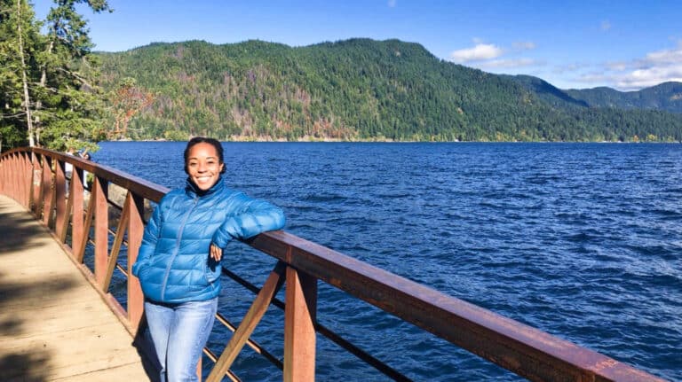 The author Chelsea Booker posing at the Devil’s Punchbowl Bridge at Lake Crescent, one of the best weekend getaways from Seattle