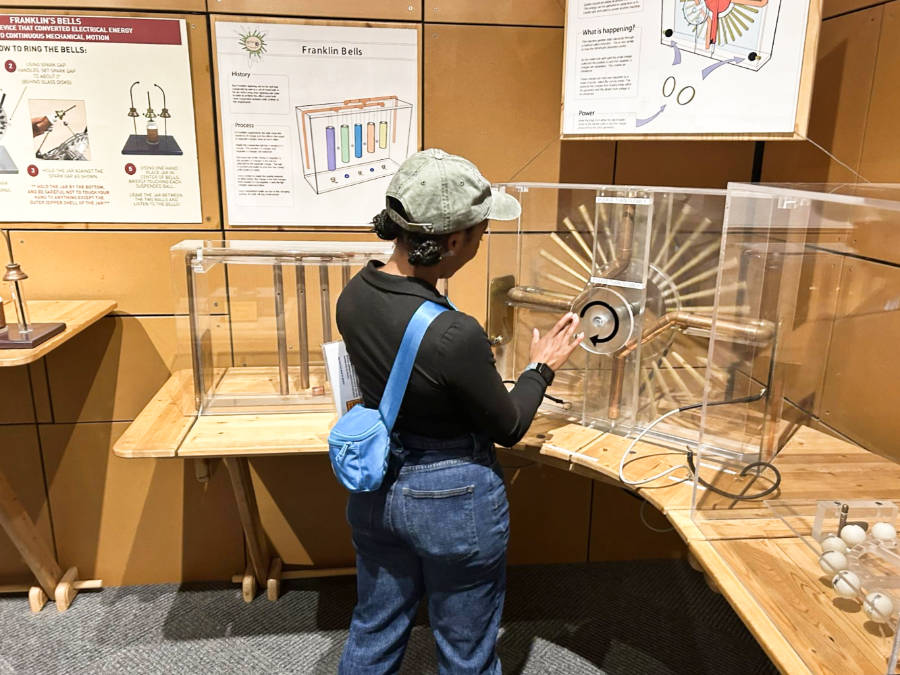 The author, Chelsea, exploring at the interactive exhibits at the Spark Museum