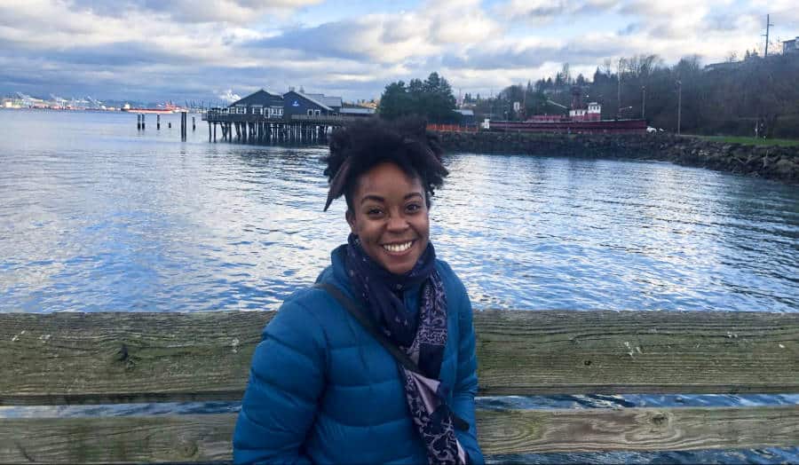The author Chelsea Booker posing at the dock along the waterfront in the North End