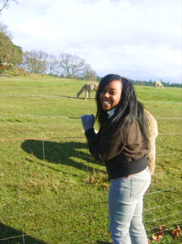 The author Chelsea Booker posing with the alpacas on San Juan Island