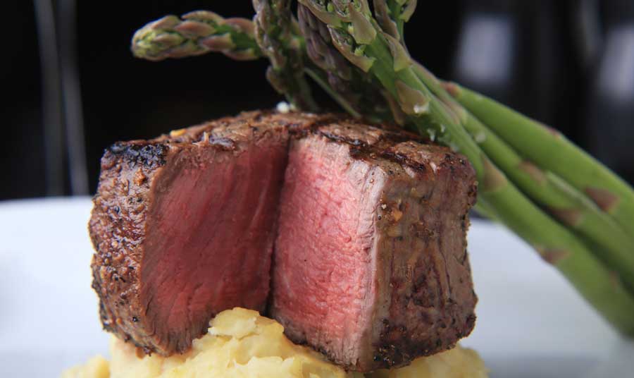 Close up view of a filet mignon with garlic in Chelsea’s Kitchen