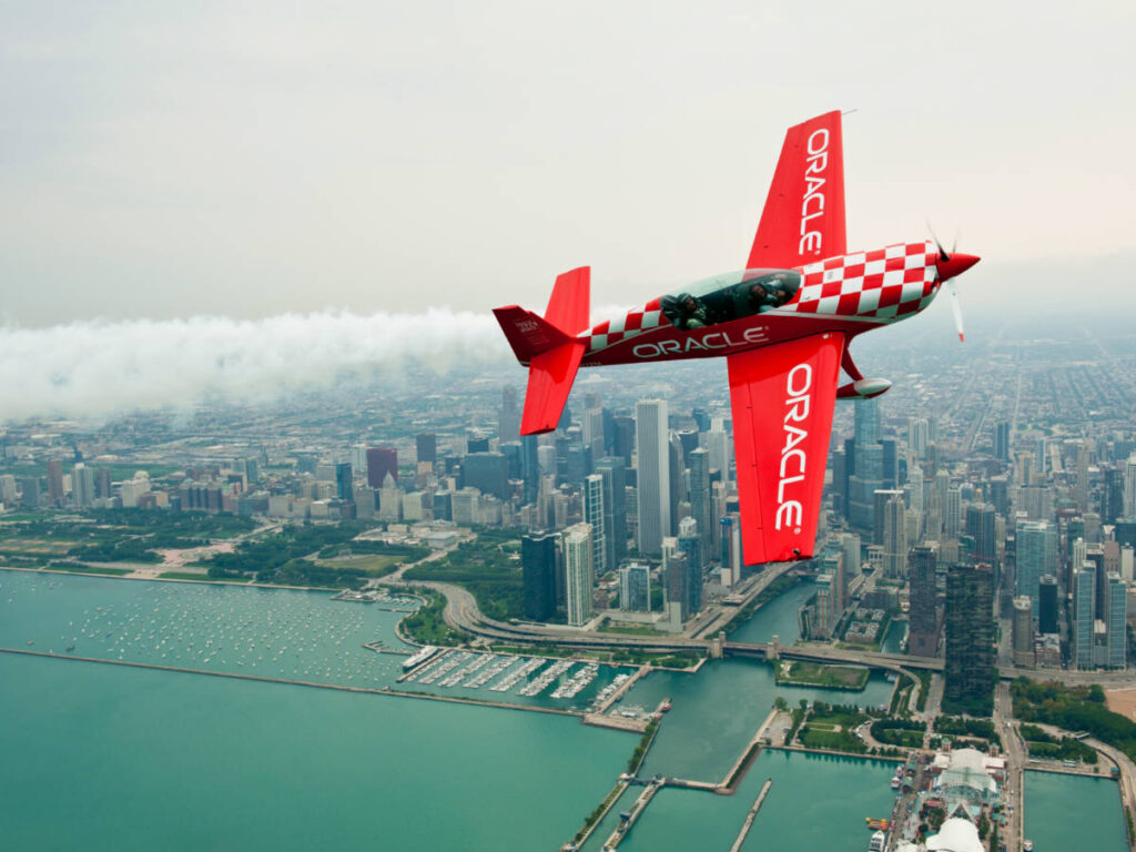 Sean Tucker of Team Oracle flies in front of the Chicago skyline during the Chicago Air and Water Show Media Day