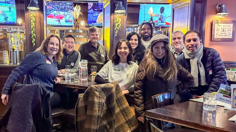 People smiling for a photo during the Travel Lemming's Chicago Community Meetups