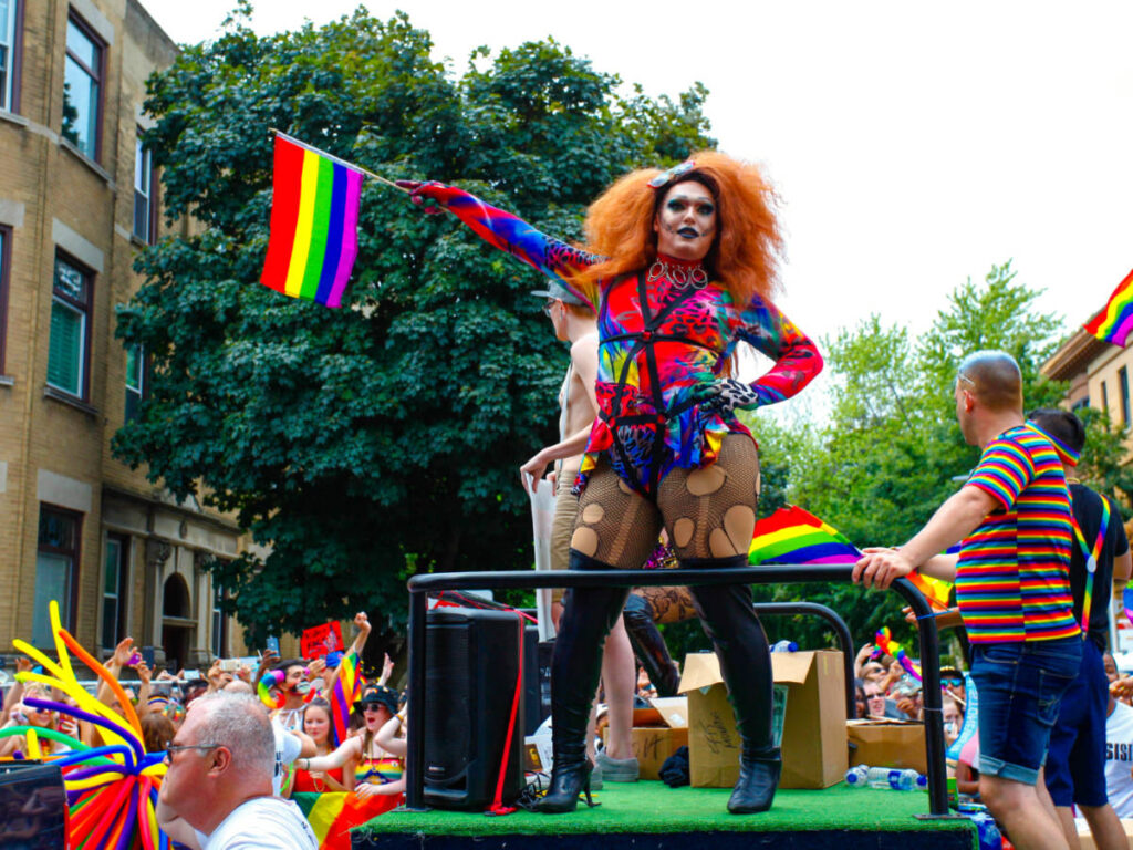 A person waving a rainbow pride flag during the Chicago Pride Fest