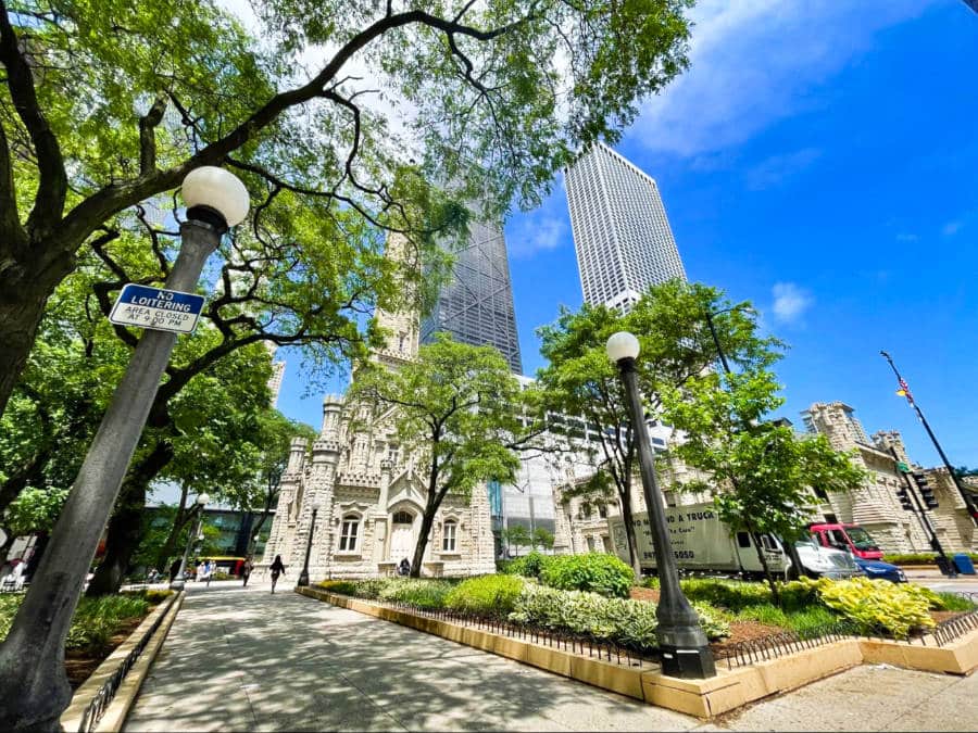 Exterior view of the Chicago Water Tower on N Michigan Ave with a clear blue sky in the background