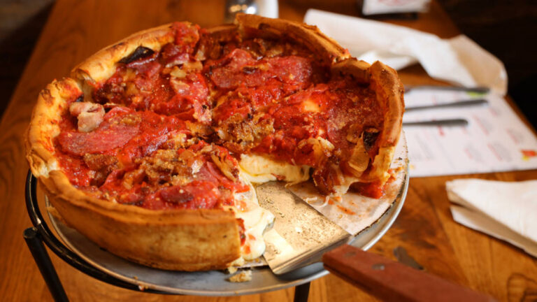 A whole Chicago-style deep-dish pizza on a table