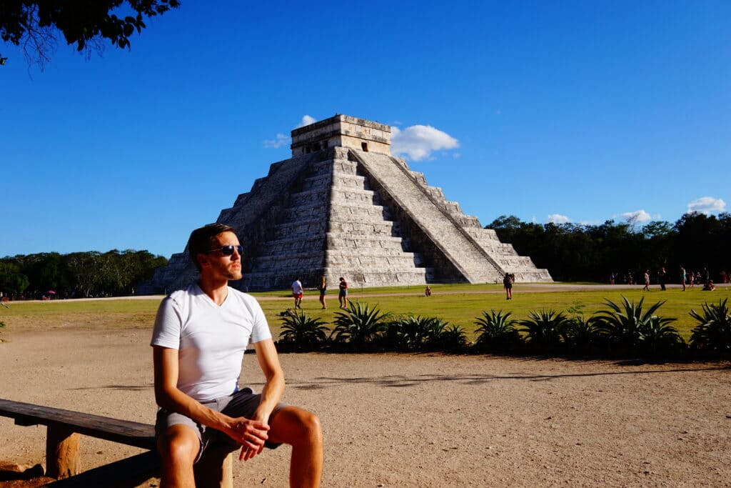 Author Nate sitting at a bench near Chichen Itza
