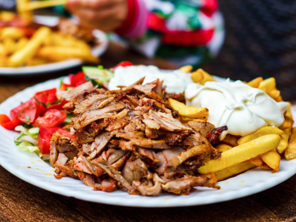 A plate of chicken shawarma and fries