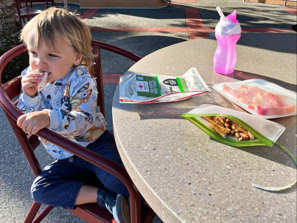 A child sitting down for breakfast at the patio in Disney