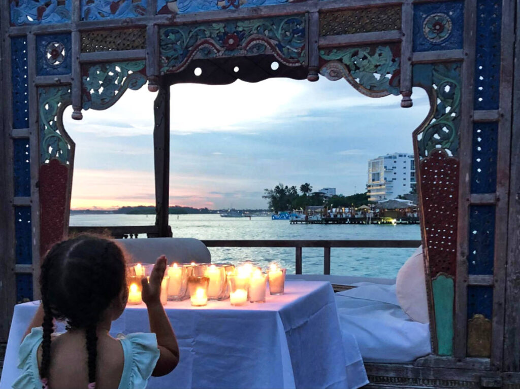 A kid enjoying the sunset view from Boca Marina