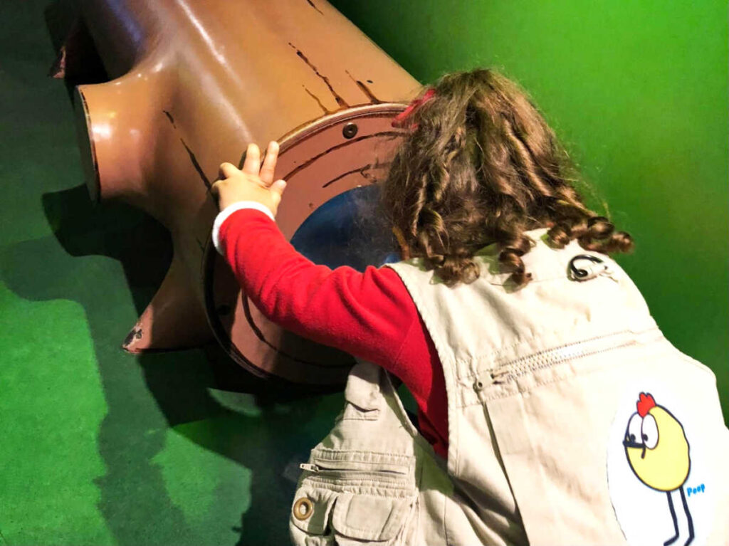 The author's daughter playing around the forest exhibit of Boston Children’s Museum