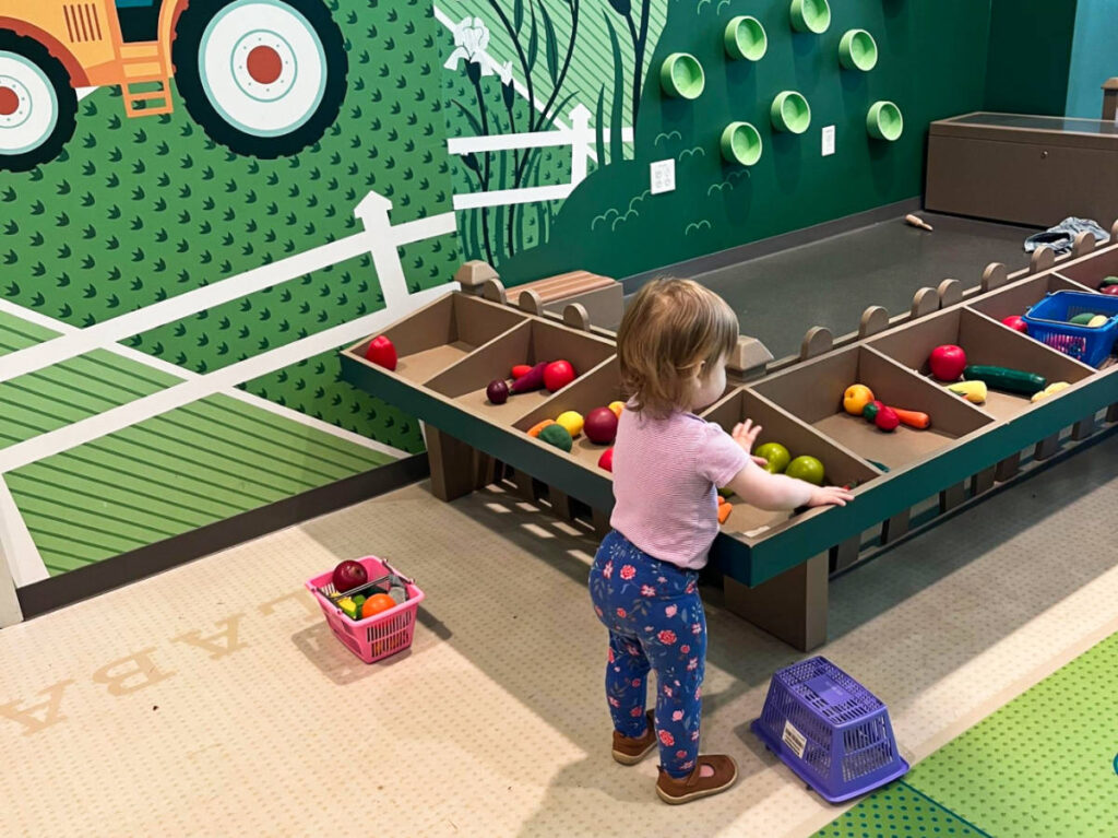 A child playing the toys in the Tennessee State Museum