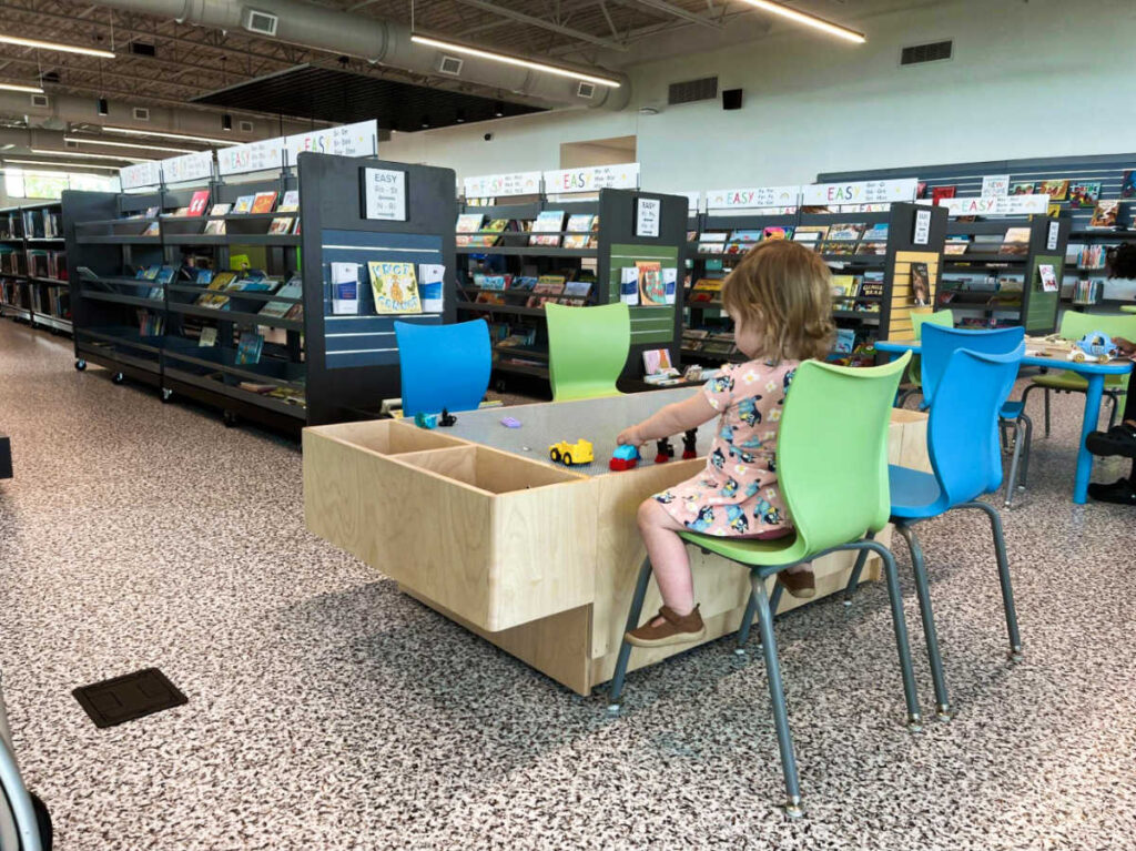A child playing legos on the table inside Donelson Library