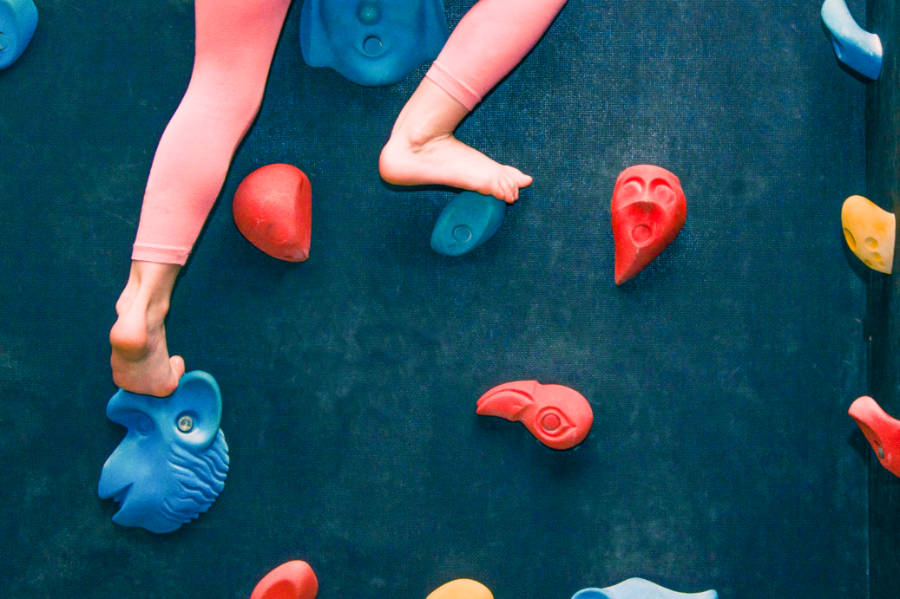 View of the child's feet wall climbing